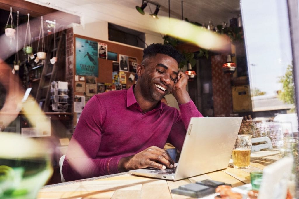 Person sitting in a home office using a Lenovo PC