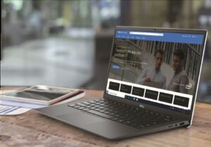 Dell laptop open to Dell Technologies Premier Solutions page with reflection off the screen of people talking. 