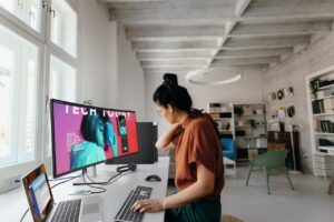 Young woman working in a modern office setting. 