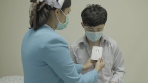 A nurse at Ramkhamhaeng Hospital in Thailand checks a patient's vitals. 