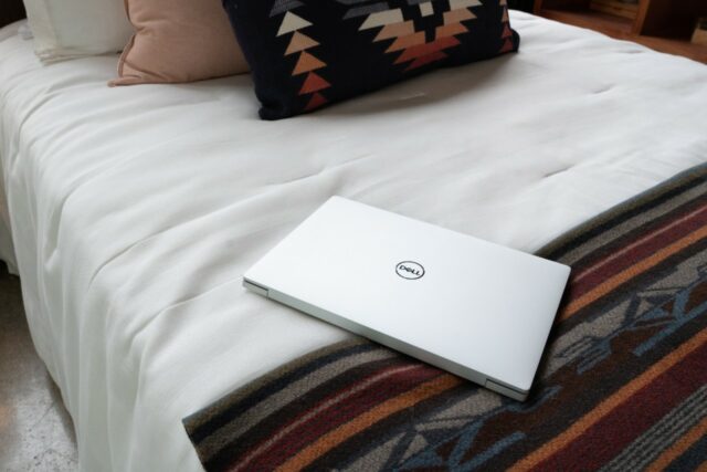 XPS 13 Plus resting on a bedspread.