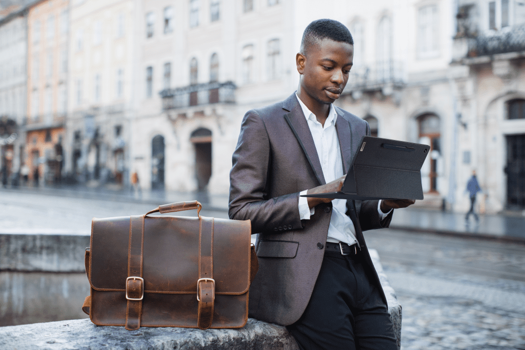 Person using IdeaPad Duet5 Chromebook outdoors on a city street