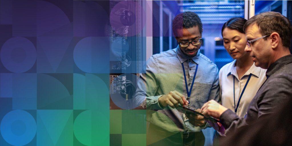 Collaborators in a data center reviewing info on a tablet.