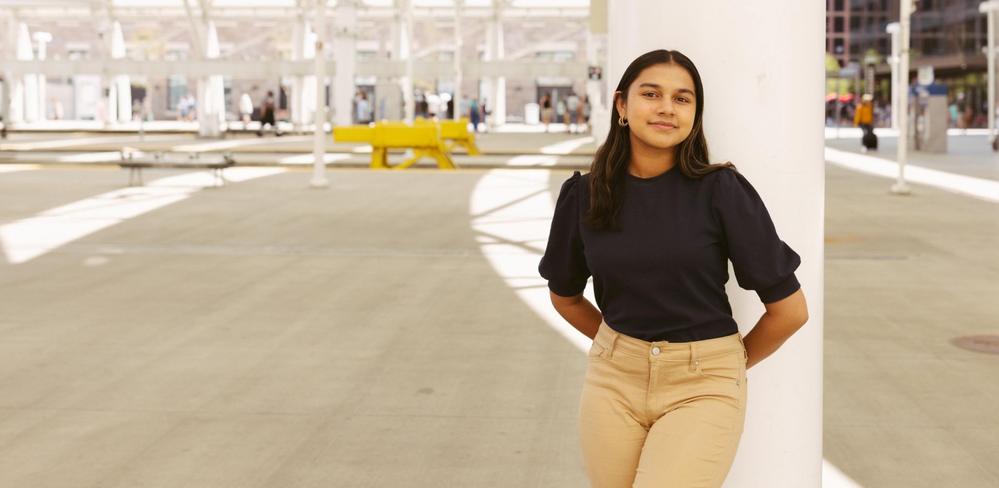 Gitanjali Rao standing in an open industrial area.