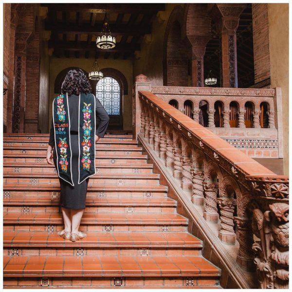 Dr. Maricela Becerra is standing facing away from the camera, looking at the top of the stairs.