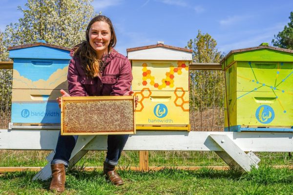 Leigh-Kathryn in front of beehives