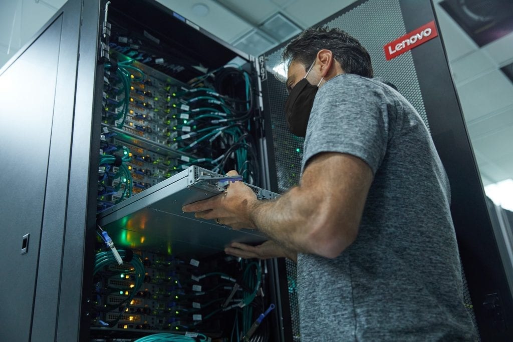 Lenovo technician installing a large data center rack.