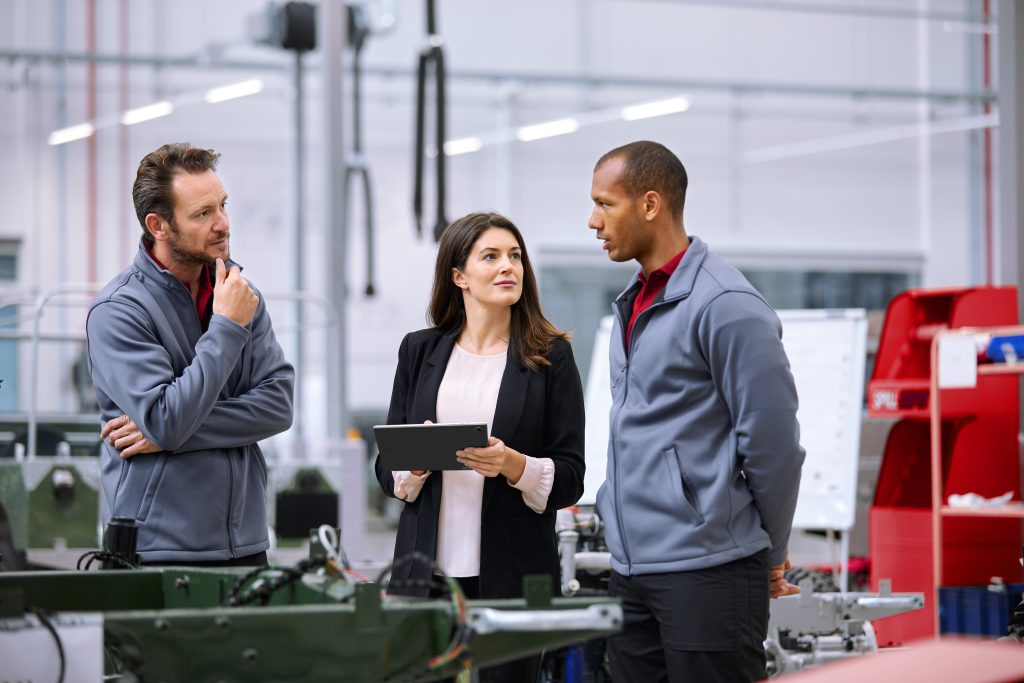 brand image - Colleagues on a production line discussing project.