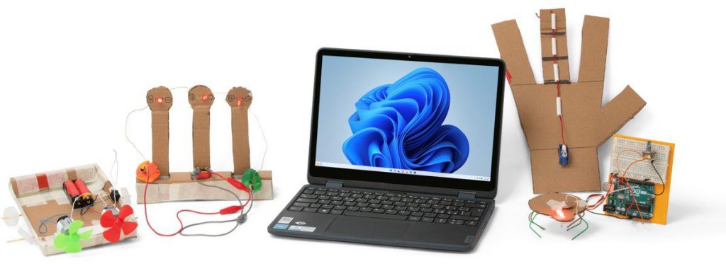 New education packaging activities beside Lenovo laptop.