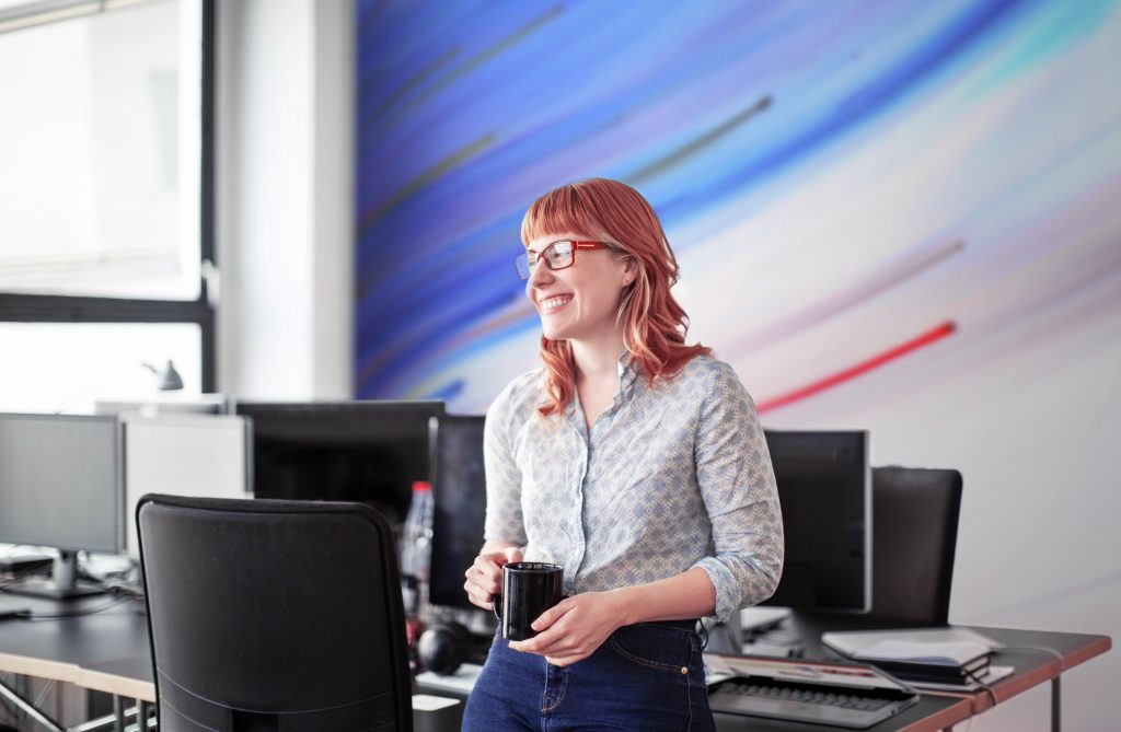 Brand image - Work Life. Woman in a conference room at work in a casual office environment.